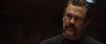 Movie still from “Only the Brave” (2017), directed by Joseph Kosinski – A person wearing glasses and a black shirt; Close Up shot, Over the shoulder angle