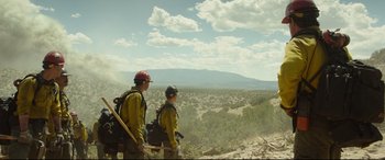 Movie still from “Only the Brave” (2017), directed by Joseph Kosinski – Two men standing on top of a hill looking out over a valley; Extreme Wide shot, Low angle