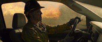 Movie still from “Only the Brave” (2017), directed by Joseph Kosinski – A man in a yellow jacket driving in a car; Medium shot, Over the shoulder angle