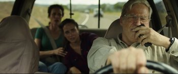 Movie still from “Only the Brave” (2017), directed by Joseph Kosinski – Three people in the back of a car on a road; Close Up shot, Over the shoulder angle