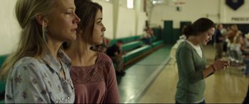 Movie still from “Only the Brave” (2017), directed by Joseph Kosinski – Two young women standing next to each other in a gym; Close Up shot, Over the shoulder angle