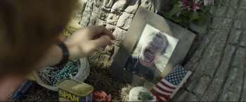 Movie still from “Only the Brave” (2017), directed by Joseph Kosinski – A picture of a person with a picture of a man; Close Up shot, Low angle
