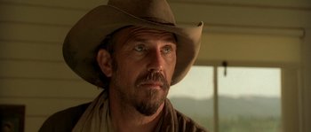 Movie still from “Open Range” (2003), directed by Kevin Costner – A person wearing a cowboy hat; Close Up shot, Low angle