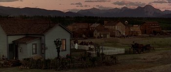 Movie still from “Open Range” (2003), directed by Kevin Costner – An image of an old western town at dusk; Extreme Wide shot, High angle
