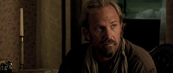Movie still from “Open Range” (2003), directed by Kevin Costner – A person with a beard; Close Up shot, Over the shoulder angle