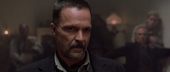 Movie still from “Open Range” (2003), directed by Kevin Costner – A person wearing a suit and tie; Close Up shot, Low angle