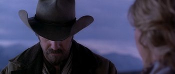 Movie still from “Open Range” (2003), directed by Kevin Costner – A man with a beard wearing a cowboy hat; Close Up shot, Over the shoulder angle