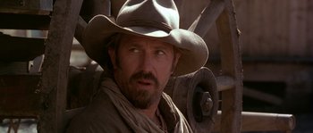 Movie still from “Open Range” (2003), directed by Kevin Costner – A person wearing a cowboy hat; Close Up shot, Over the shoulder angle