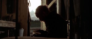 Movie still from “Open Range” (2003), directed by Kevin Costner – A man sitting in front of an open window; Close Up shot, Low angle