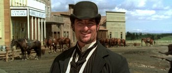 Movie still from “Open Range” (2003), directed by Kevin Costner – A man wearing a black hat and a black suit; Close Up shot, Low angle