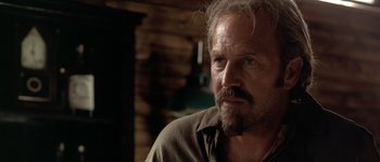 Movie still from “Open Range” (2003), directed by Kevin Costner – An older man with a beard looking into the distance; Close Up shot, Over the shoulder angle
