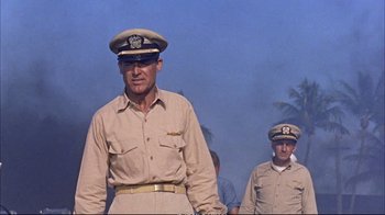 Movie still from “Operation Petticoat” (1959), directed by Blake Edwards – A man in a military uniform standing next to another man in a military uniform; Medium shot, Low angle