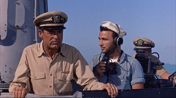 Movie still from “Operation Petticoat” (1959), directed by Blake Edwards – Two men are talking to each other on a boat; Medium shot, Low angle