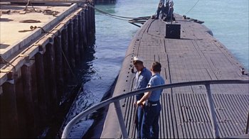 Movie still from “Operation Petticoat” (1959), directed by Blake Edwards – Two men standing on the side of a boat; Extreme Wide shot, High angle