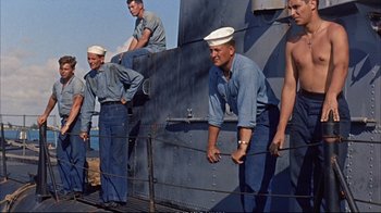 Movie still from “Operation Petticoat” (1959), directed by Blake Edwards – A group of men standing on top of a boat; Medium shot, Low angle