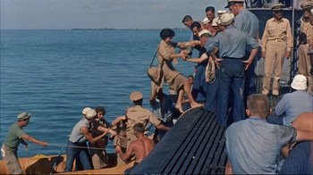 Movie still from “Operation Petticoat” (1959), directed by Blake Edwards – A group of people standing on a boat in the water; Wide shot, High angle