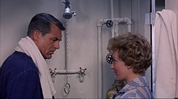 Movie still from “Operation Petticoat” (1959), directed by Blake Edwards – A man and a woman are standing in front of a pipe; Medium shot, Over the shoulder angle