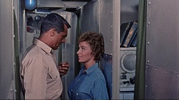 Movie still from “Operation Petticoat” (1959), directed by Blake Edwards – A man and a woman standing next to each other; Medium shot, High angle
