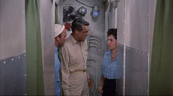 Movie still from “Operation Petticoat” (1959), directed by Blake Edwards – A group of men standing next to each other in a room; Medium shot, High angle