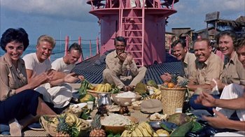 Movie still from “Operation Petticoat” (1959), directed by Blake Edwards – A group of men sitting on top of a boat; Wide shot, High angle