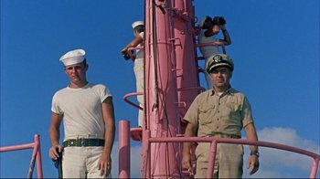 Movie still from “Operation Petticoat” (1959), directed by Blake Edwards – A group of men standing on top of a pink pole; Medium shot, Low angle