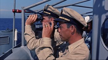 Movie still from “Operation Petticoat” (1959), directed by Blake Edwards – Two men in military uniforms looking through binoculars; Medium shot, High angle