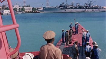 Movie still from “Operation Petticoat” (1959), directed by Blake Edwards – A group of men standing on the side of a boat; Extreme Wide shot, High angle