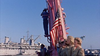 Movie still from “Operation Petticoat” (1959), directed by Blake Edwards – A group of people standing next to each other on a boat; Medium shot, Low angle