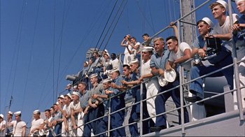 Movie still from “Operation Petticoat” (1959), directed by Blake Edwards – A large group of sailors on the deck of a ship; Wide shot, High angle