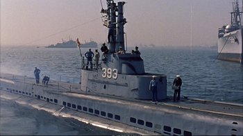 Movie still from “Operation Petticoat” (1959), directed by Blake Edwards – A group of men standing on the deck of a boat; Extreme Wide shot, High angle