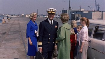 Movie still from “Operation Petticoat” (1959), directed by Blake Edwards – A man in a military uniform talking to a woman; Wide shot, Over the shoulder angle