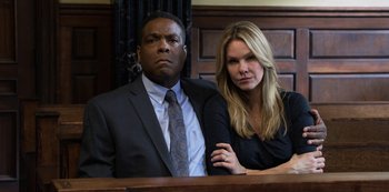 Movie still from “13 Reasons Why” (2017), created by Brian Yorkey – A man and a woman sitting in front of a judge; Medium shot, Low angle