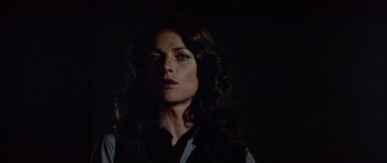 Movie still from “Orca” (1977), directed by Michael Anderson – A woman with long dark hair is looking at the camera; Close Up shot, Low angle