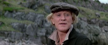 Movie still from “Orca” (1977), directed by Michael Anderson – A person wearing a hat; Close Up shot, Low angle