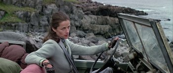 Movie still from “Orca” (1977), directed by Michael Anderson – A woman sitting in the drivers seat of a boat; Medium shot, Low angle