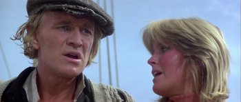 Movie still from “Orca” (1977), directed by Michael Anderson – A man and a woman talking to each other; Close Up shot, Low angle