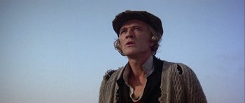 Movie still from “Orca” (1977), directed by Michael Anderson – A person wearing a hat and a sweater; Close Up shot, Low angle