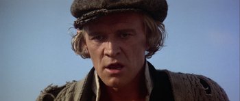 Movie still from “Orca” (1977), directed by Michael Anderson – A person wearing a hat; Close Up shot, Low angle
