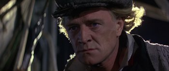 Movie still from “Orca” (1977), directed by Michael Anderson – A person wearing a hat; Close Up shot, Low angle