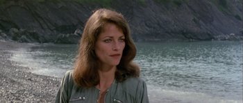 Movie still from “Orca” (1977), directed by Michael Anderson – A person near a body of water; Close Up shot, Over the shoulder angle