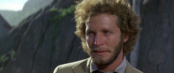 Movie still from “Orca” (1977), directed by Michael Anderson – A person wearing a suit and tie; Close Up shot, Low angle