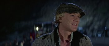 Movie still from “Orca” (1977), directed by Michael Anderson – A person wearing a hat; Close Up shot, Over the shoulder angle