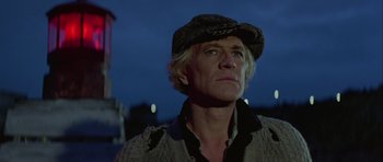 Movie still from “Orca” (1977), directed by Michael Anderson – A man wearing a hat looking up at the sky at night; Close Up shot, Low angle
