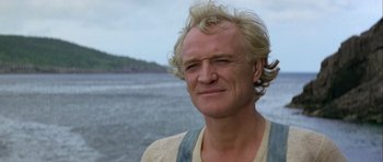 Movie still from “Orca” (1977), directed by Michael Anderson – A person wearing a shirt; Close Up shot, Low angle