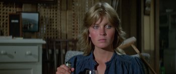 Movie still from “Orca” (1977), directed by Michael Anderson – A person holding a glass of wine; Close Up shot, Over the shoulder angle