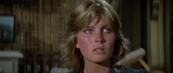 Movie still from “Orca” (1977), directed by Michael Anderson – A person with long blonde hair; Close Up shot, Low angle