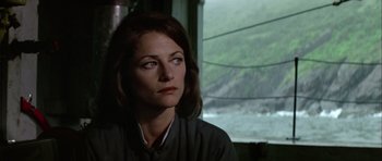 Movie still from “Orca” (1977), directed by Michael Anderson – A person sitting in front of a window; Close Up shot, Over the shoulder angle