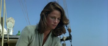 Movie still from “Orca” (1977), directed by Michael Anderson – A person on a boat in the water; Close Up shot, Low angle