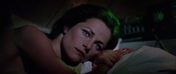 Movie still from “Orca” (1977), directed by Michael Anderson – A person laying in a bed; Close Up shot, High angle