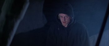 Movie still from “Orca” (1977), directed by Michael Anderson – A man wearing a black hooded jacket and looking at the camera; Close Up shot, Low angle